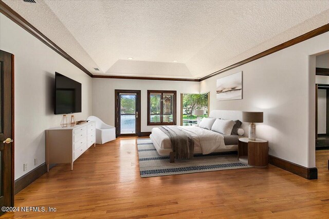 13612 Mcqueens Ct, Jacksonville, FL 32225 - bedroom with ornamental molding, a tray ceiling, access to outside, and light hardwood / wood-style floors