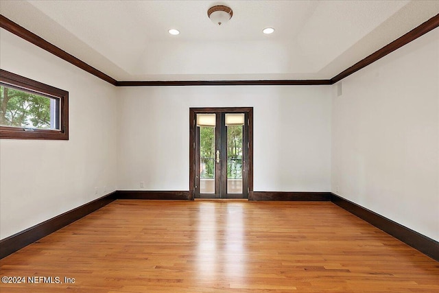 13612 Mcqueens Ct, Jacksonville, FL 32225 - spare room with french doors, a raised ceiling, and light hardwood / wood-style flooring