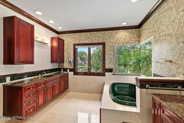 13612 Mcqueens Ct, Jacksonville, FL 32225 - bathroom featuring crown molding, vanity, a bath, a textured ceiling, and tile patterned floors