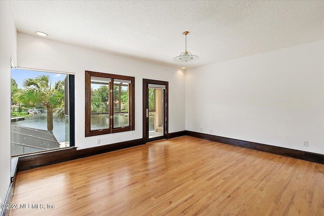 13612 Mcqueens Ct, Jacksonville, FL 32225 - unfurnished room featuring a textured ceiling and light wood-type flooring