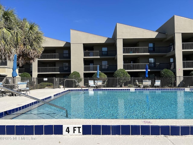 view of swimming pool featuring a patio area