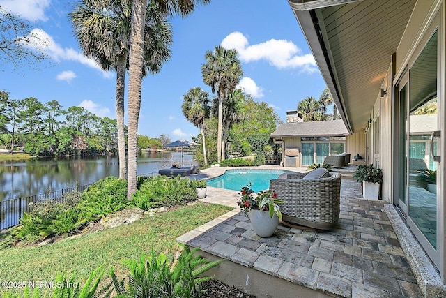 view of swimming pool featuring a fenced in pool, a patio area, a water view, and fence