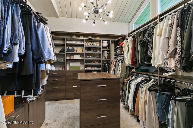 spacious closet featuring a chandelier