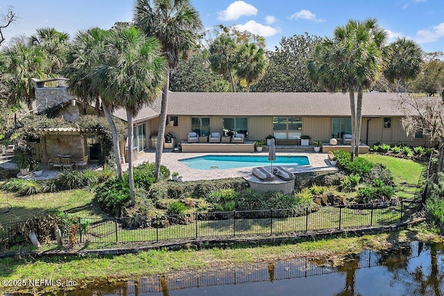 view of swimming pool featuring a patio area, fence, and a fenced in pool