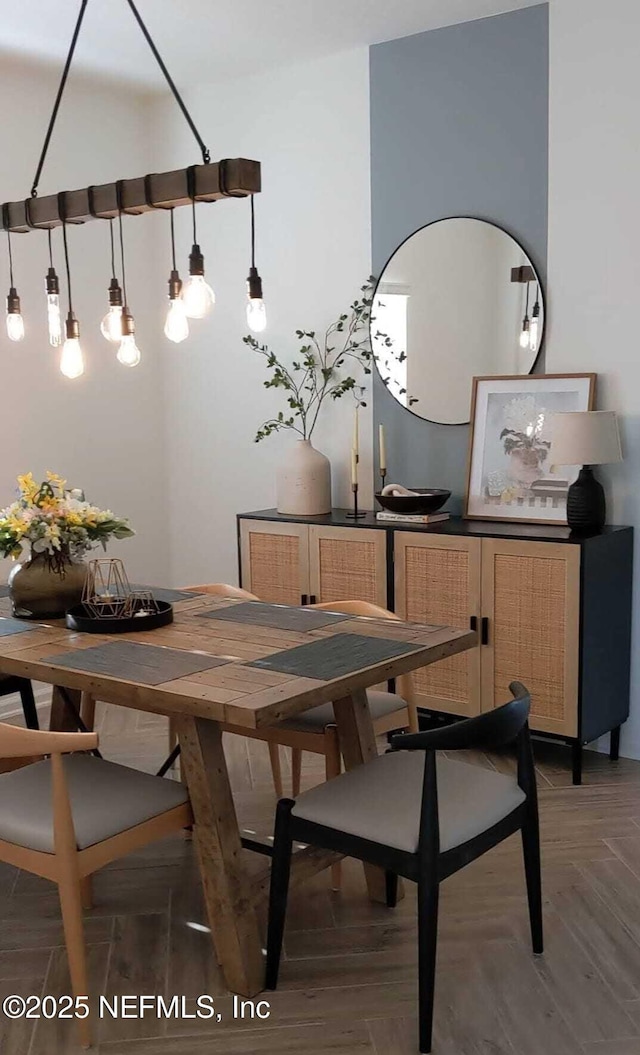 dining room featuring dark parquet flooring