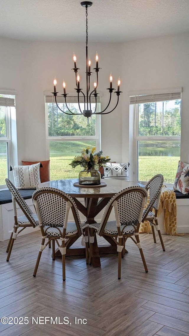 dining space featuring breakfast area, parquet floors, and a textured ceiling