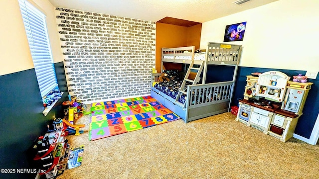 carpeted bedroom with brick wall and a textured ceiling