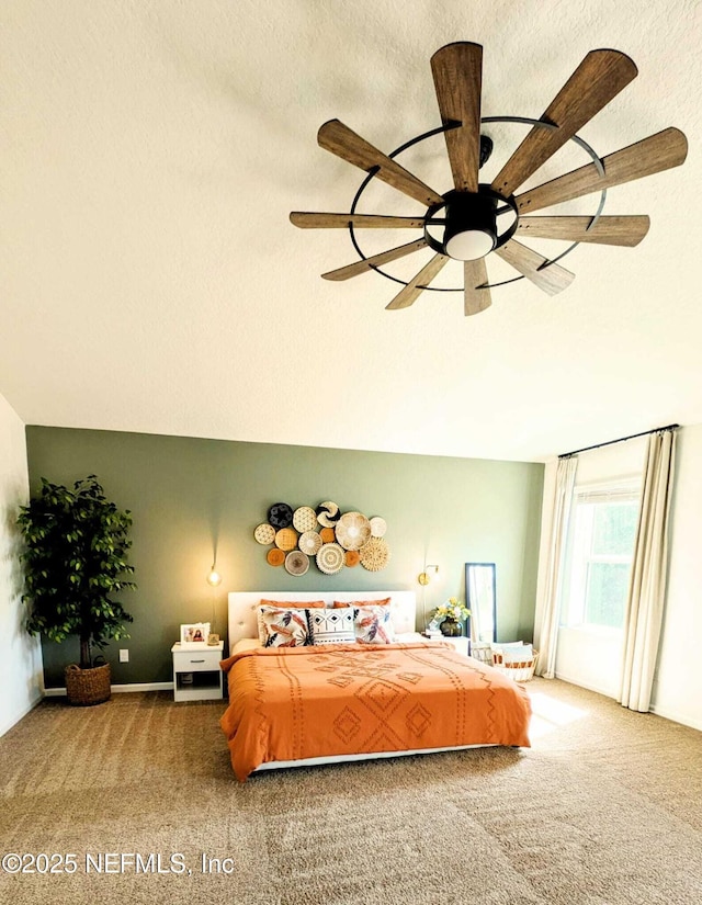 bedroom featuring ceiling fan, a textured ceiling, and carpet flooring