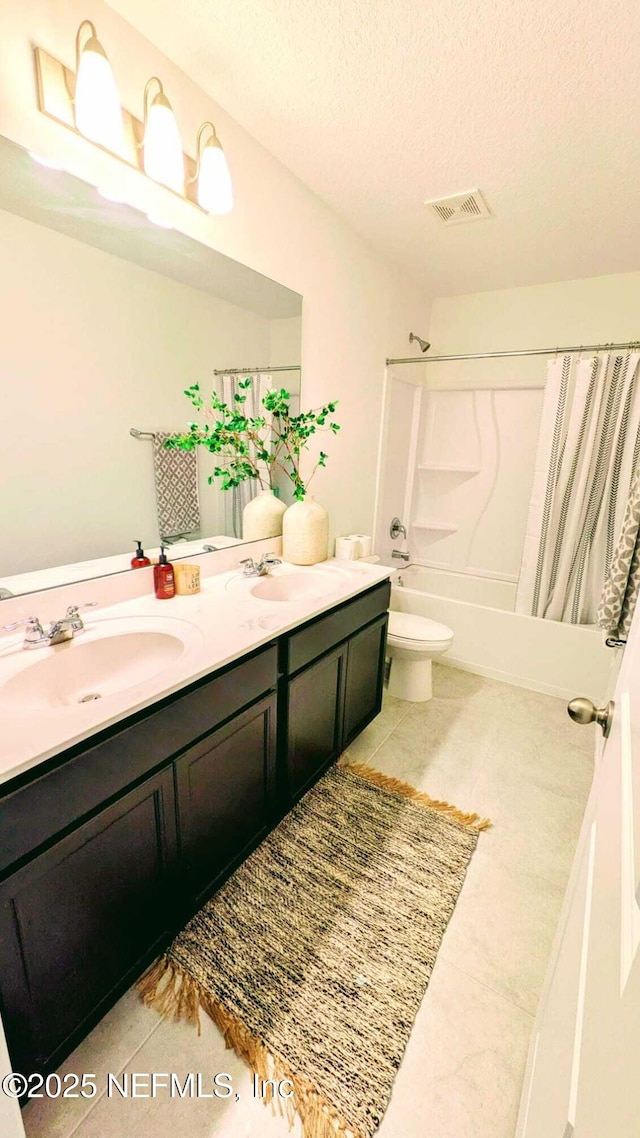 full bathroom with toilet, a textured ceiling, vanity, shower / bath combo, and tile patterned flooring