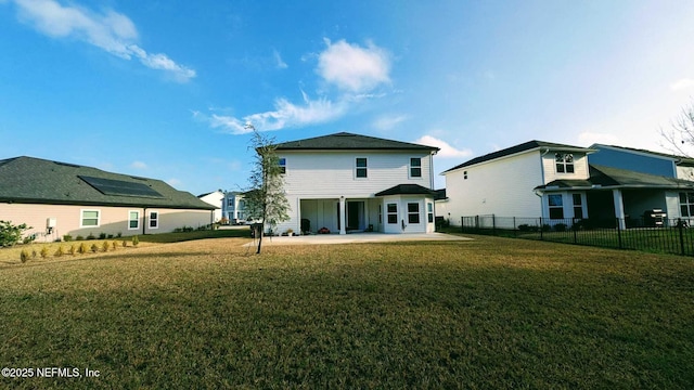 back of house with a yard and a patio