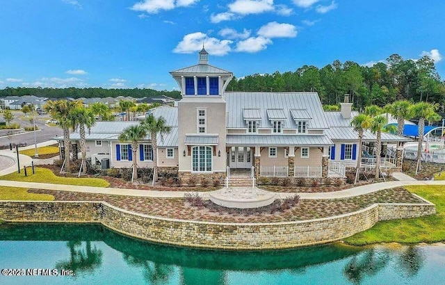 rear view of property featuring a water view