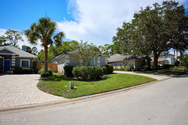 ranch-style home with a front lawn