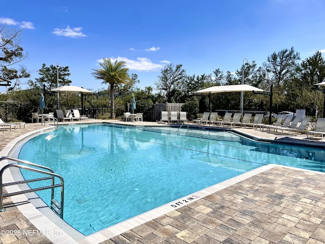 pool featuring a patio and fence