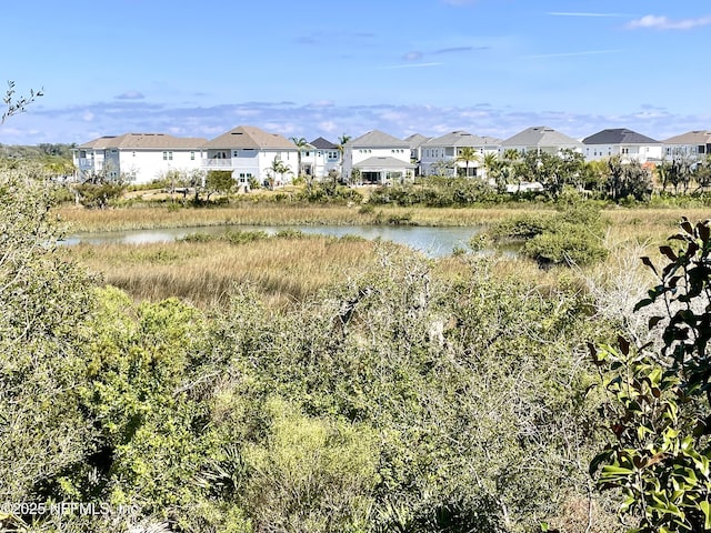 view of yard featuring a water view and a residential view