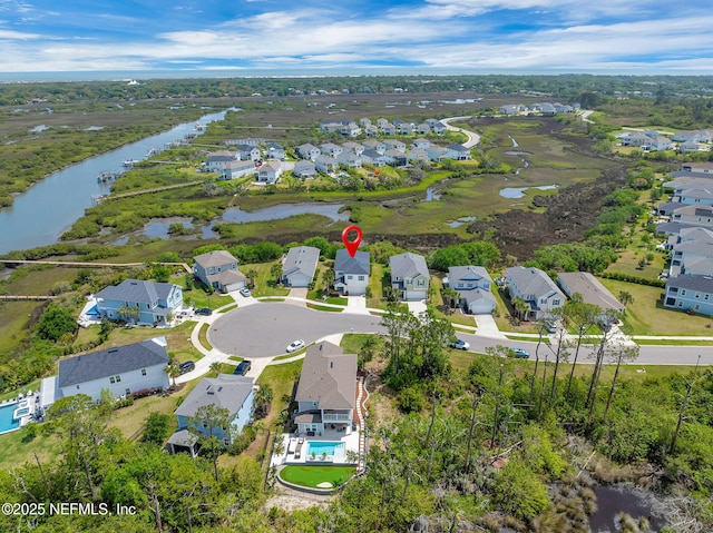 drone / aerial view featuring a water view and a residential view