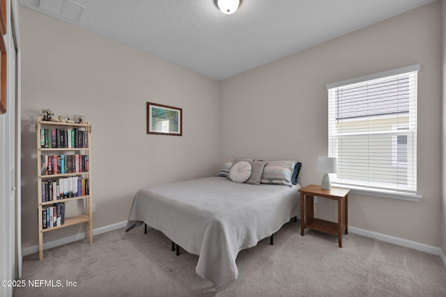 carpeted bedroom with visible vents and baseboards