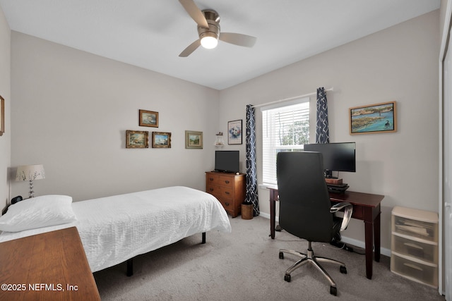 carpeted bedroom featuring baseboards and a ceiling fan