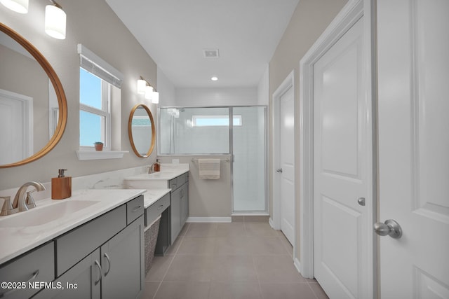 full bathroom with a sink, visible vents, tile patterned floors, and a stall shower