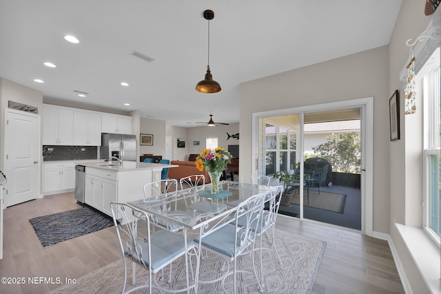 dining space featuring light wood-style floors, ceiling fan, visible vents, recessed lighting, and baseboards