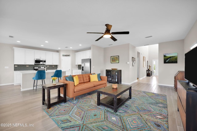 living area with recessed lighting, light wood-style floors, visible vents, and ceiling fan