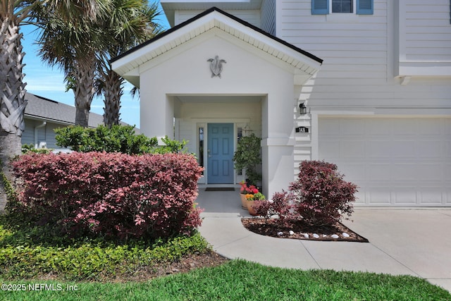 property entrance featuring driveway and a garage