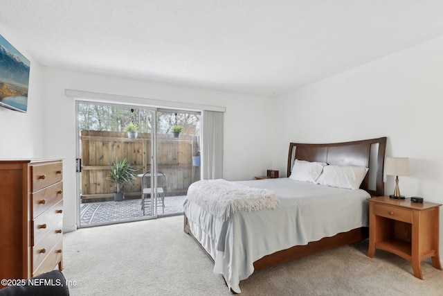 carpeted bedroom featuring access to exterior