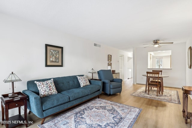 living room featuring hardwood / wood-style flooring and ceiling fan