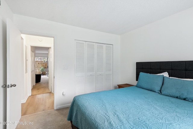 bedroom with a closet and light colored carpet