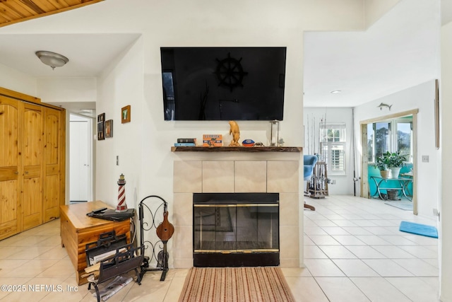 living area with light tile patterned floors, a fireplace, and lofted ceiling