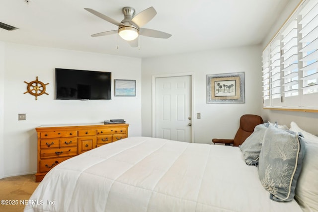 carpeted bedroom featuring visible vents and ceiling fan