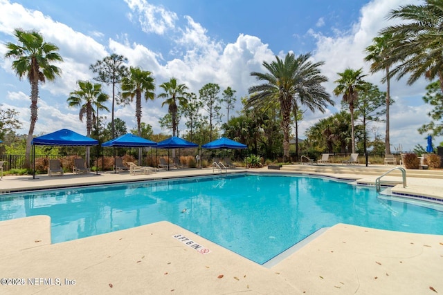 community pool featuring a patio and fence