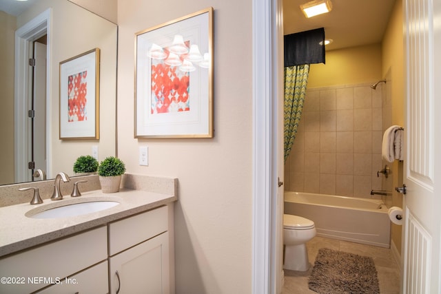 full bathroom featuring vanity, tile patterned flooring, toilet, and tiled shower / bath