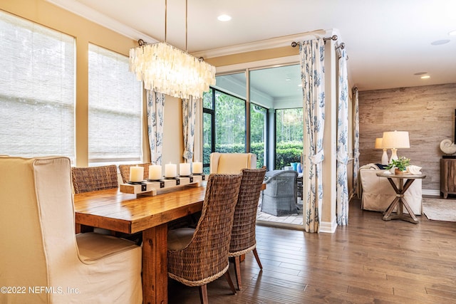 dining area with a chandelier, crown molding, and dark hardwood / wood-style floors