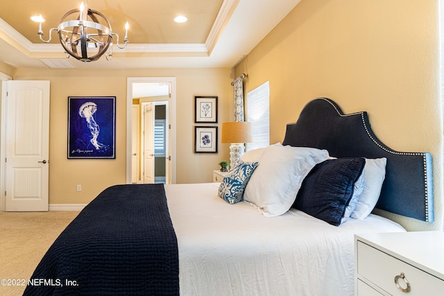 carpeted bedroom with a tray ceiling, crown molding, and a notable chandelier