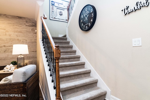 stairway with wood walls