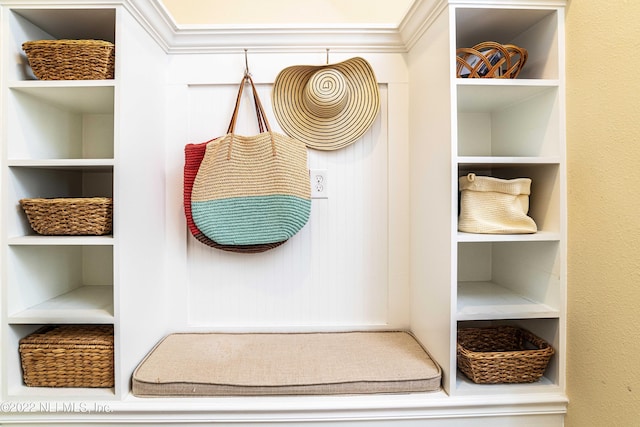 mudroom featuring built in shelves