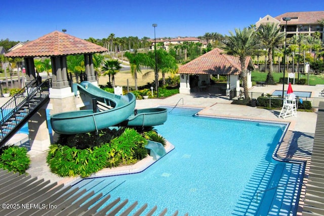 view of pool with a gazebo and a water slide