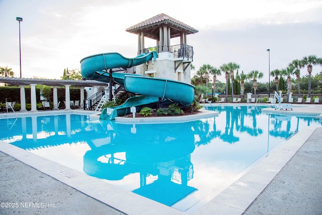 view of pool featuring a pergola and a water slide