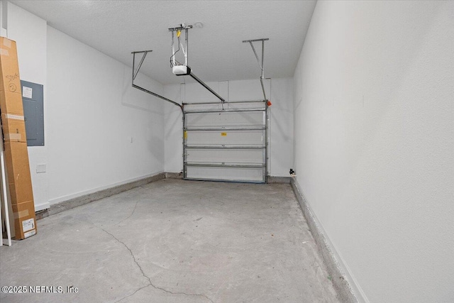 garage featuring electric panel, baseboards, and a garage door opener