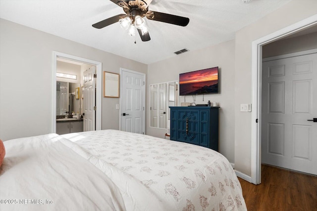 bedroom with connected bathroom, ceiling fan, hardwood / wood-style flooring, and a textured ceiling