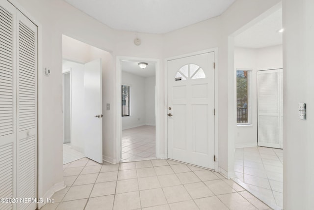 entrance foyer with baseboards and light tile patterned flooring