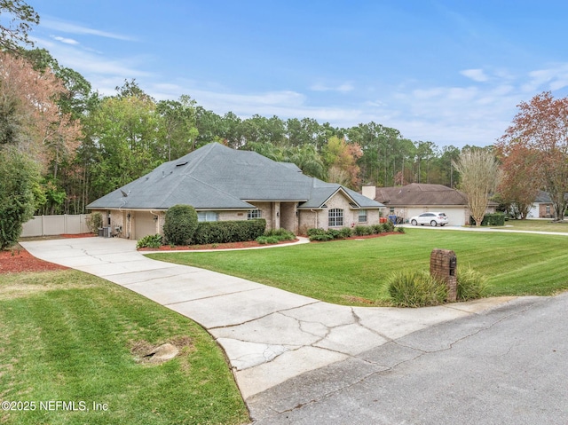 ranch-style home featuring a garage, driveway, a front yard, and fence