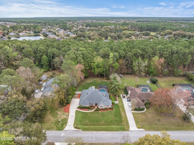 birds eye view of property with a water view and a forest view