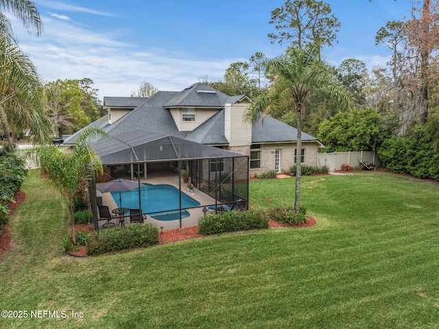 rear view of property with a patio, a lawn, glass enclosure, a fenced backyard, and an outdoor pool