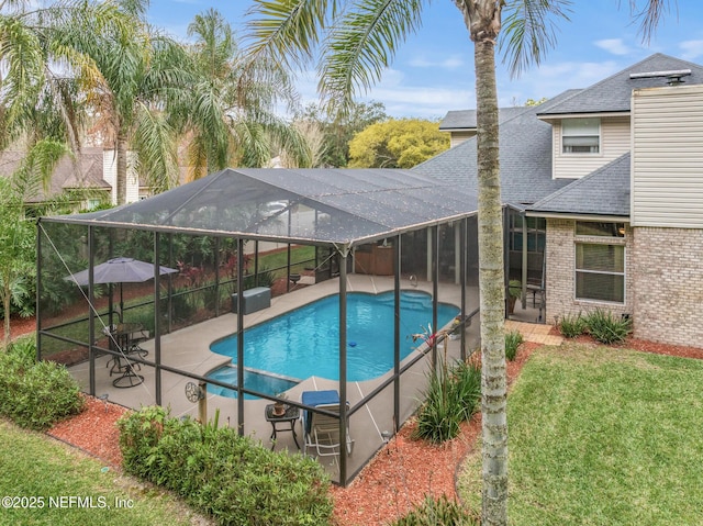 view of swimming pool featuring a patio, a lawn, a lanai, and a fenced in pool