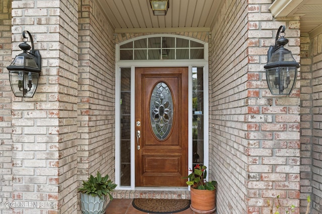 property entrance featuring brick siding