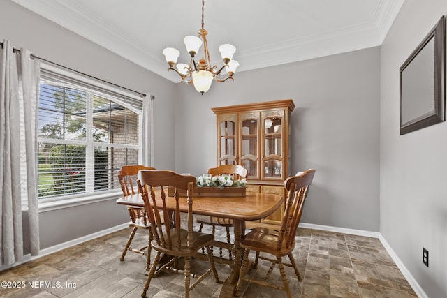 dining space with crown molding, stone finish flooring, a chandelier, and baseboards