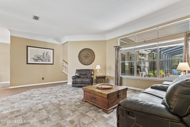 living room featuring baseboards, stairs, visible vents, and crown molding