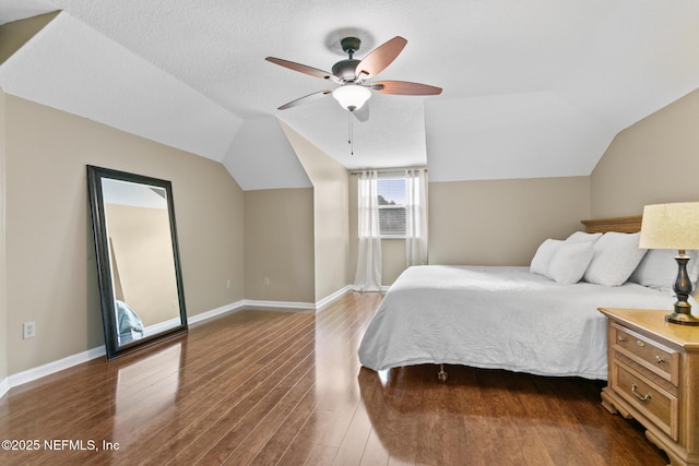 bedroom with ceiling fan, vaulted ceiling, baseboards, and dark wood finished floors