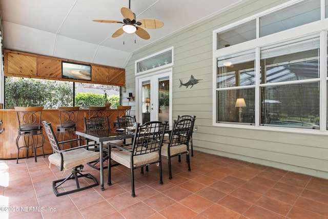 sunroom with lofted ceiling, french doors, and a ceiling fan